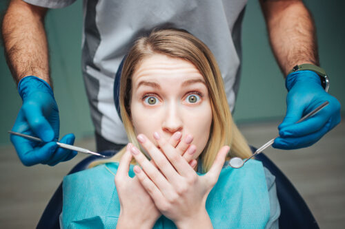 woman in dental chair scared of dentist