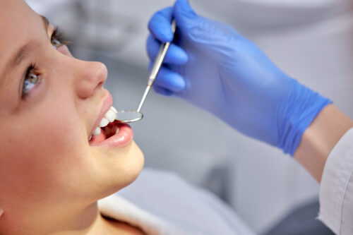 Healthy teeth and medicine concept.Close-up photo of child's face, sits on couch during checkup, before treatment