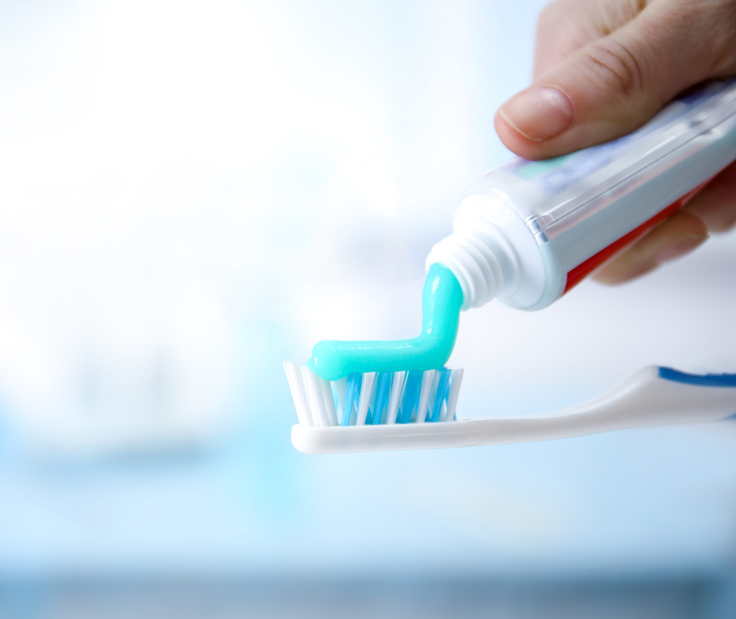 Toothbrush and toothpaste on blurred background