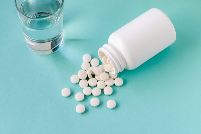 glass of water, medication spilled