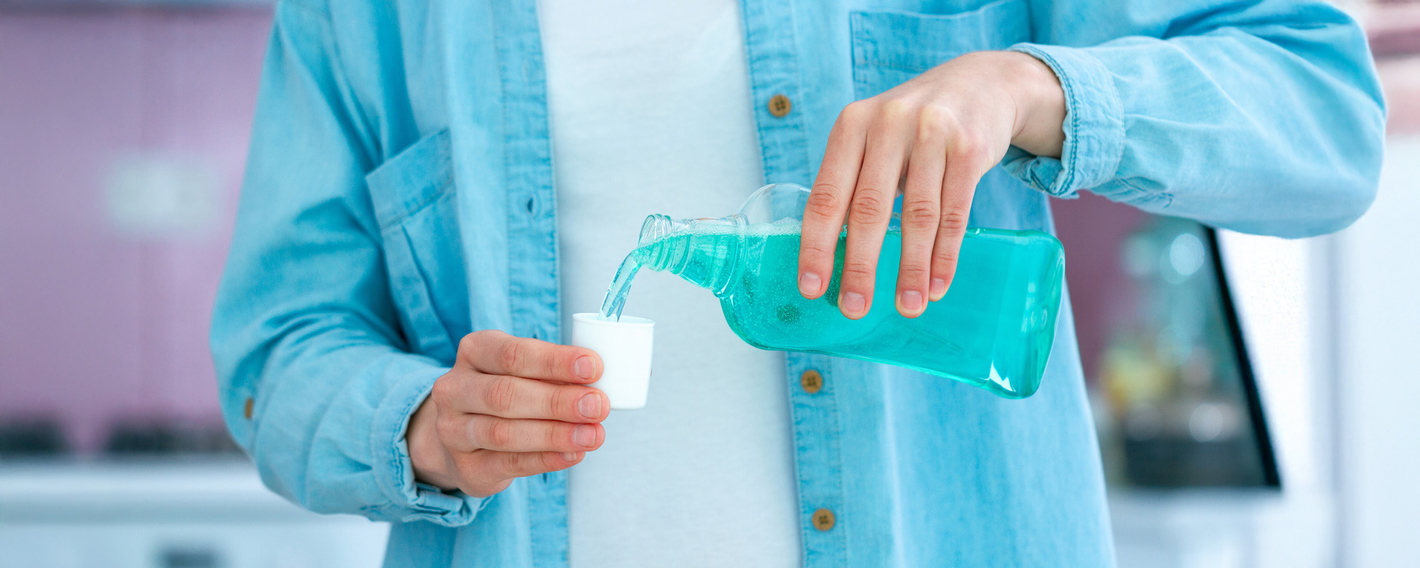 Woman using mouthwash gel for fresh breath and rinsing teeth