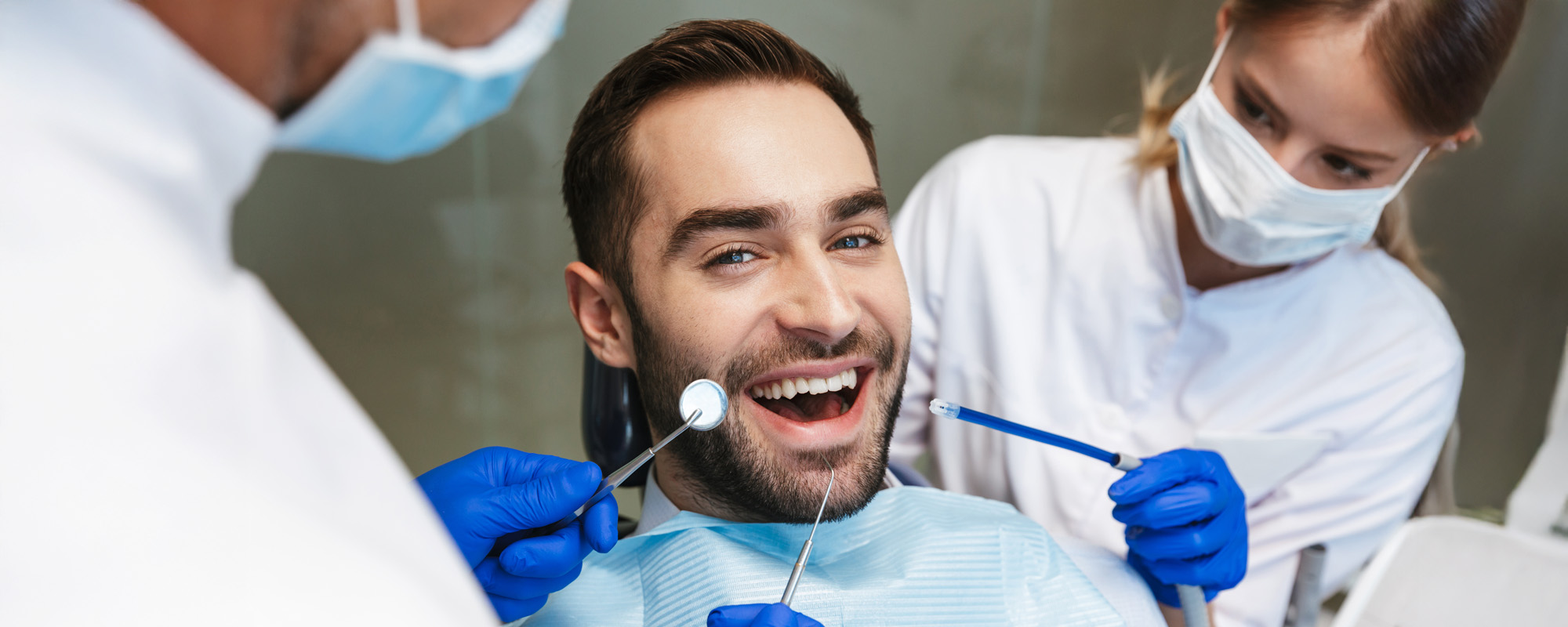 happy young man sitting in medical dentist center