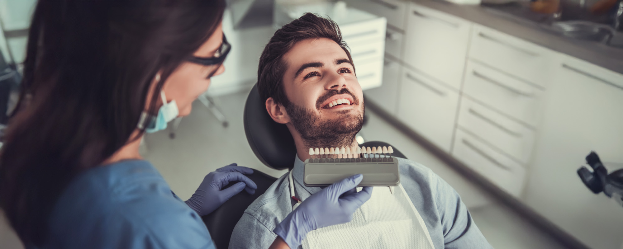 patient at dentist getting teeth whitened
