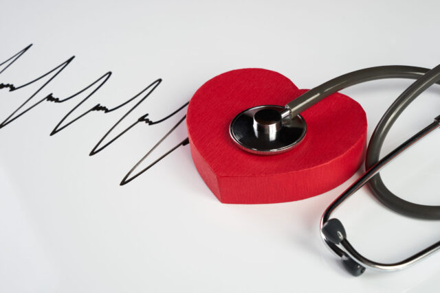 Medical stethoscope and red heart with cardiogram isolated on white. Cardiac therapeutics assistance, pulse beat measure document, arrhythmia pacemaker medical healthcare concept